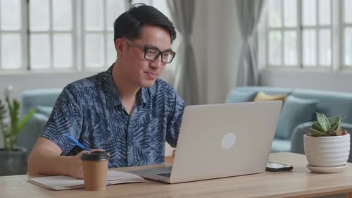 Man Video Calling on Laptop at Home
