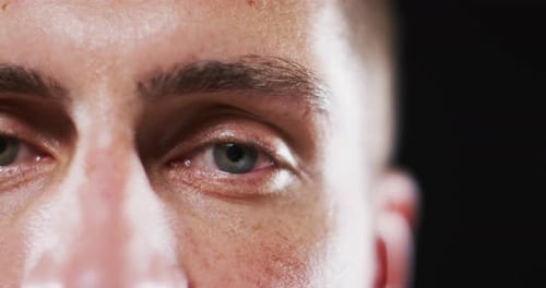 Close up portrait of face of caucasian man with focus on blinking eye