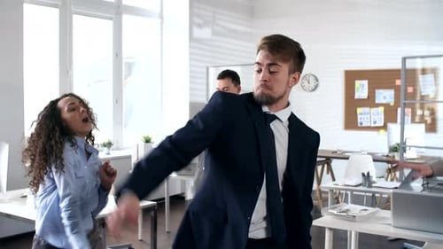 Ecstatic Business People Dancing in the Office