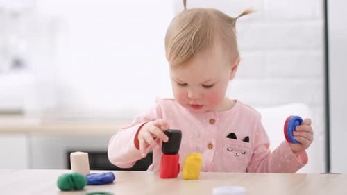 Cute Child Playing With Modeling Clay at Home