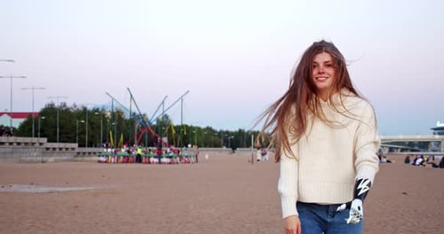 Smiling Woman with Prosthetic Hand Walks on Beach