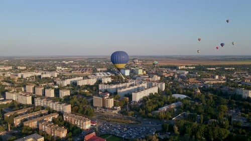 Aerial View of City with Hot Air Balloons