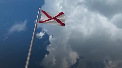 Realistic Alabama State Flag Waving in Cloudy Sky