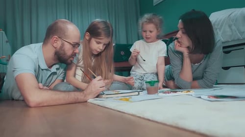 Family Painting Together on Floor at Home
