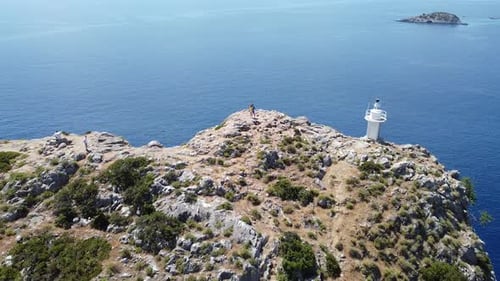 A Couple in Love Stands on a Mountain and Kisses