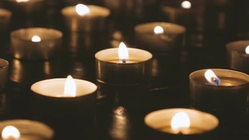 Glowing Candles Flicker in the Dark