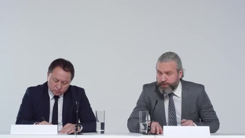 Professionals Speaking at a Press Conference