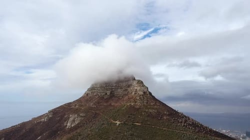 Fogs Forming at the Peak of a Mountain Under Low Forming Clouds