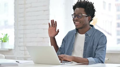 Smiling Young Adult on Video Call with Laptop
