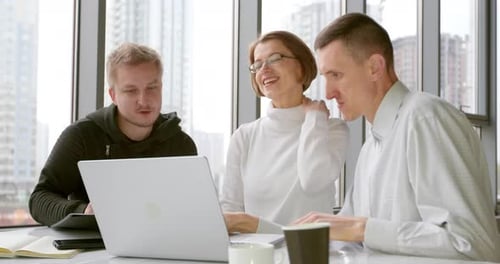 Meeting people sitting by the laptop in the office. Business people brainstorming.