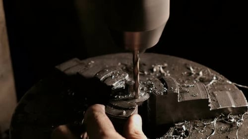 Metalworker Drilling Steel Detail. Close-up of Drill Bit with Metal Shavings. Mechanical Working in