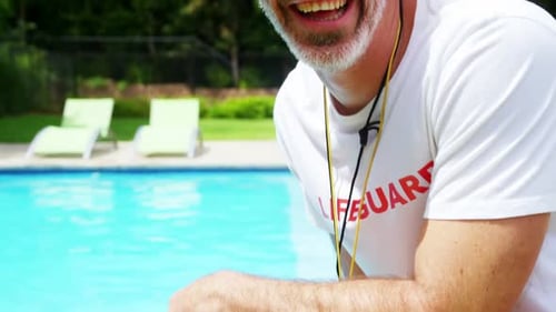 Happy lifeguard at pool side
