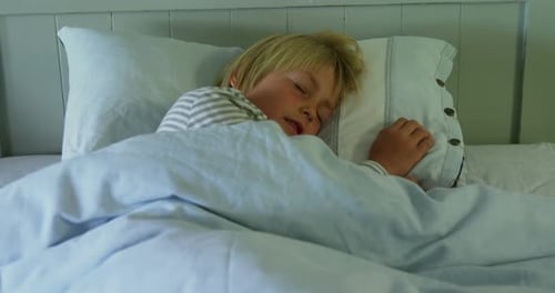 Blond Child Sleeping Peacefully in Bed