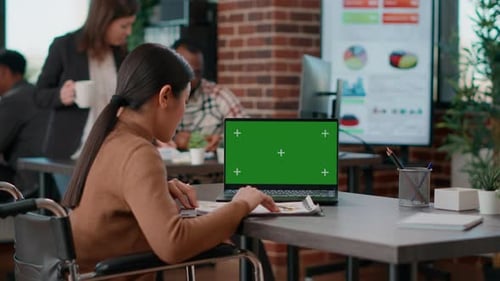 Businesswoman Working in Disability Friendly Office with Greenscreen