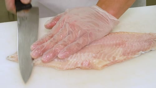 Cutting Fish Fillet on Cutting Board Close Up