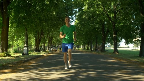 Athletic Young Man Running in Public Park