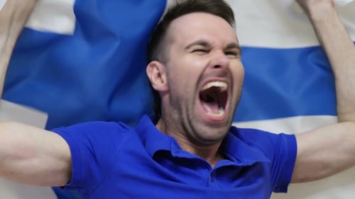 Excited Man Yelling and Waving Flag in Celebration