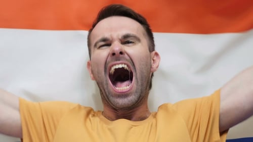 Man Yelling and Holding Flag Close Up
