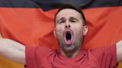 Enthusiastic Man Cheering with German Flag, Close Up
