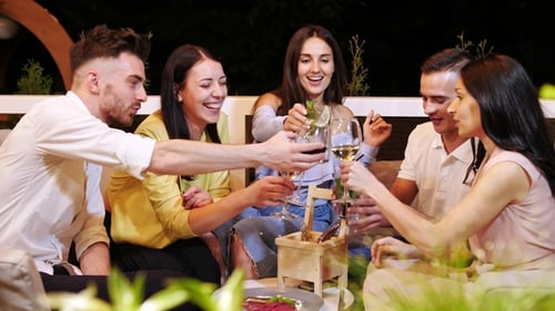 Group of Friends Are Clink Glasses with Drinks at Cafe