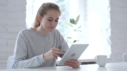 Woman Using Tablet for Online Shopping With Card