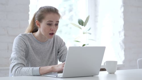 Woman Reacts Bad News on Laptop Computer