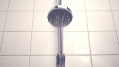 Shower Head Streaming Water in Modern Bathroom