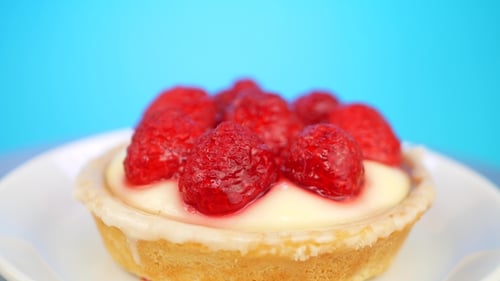 Close-up of Single Raspberry Tart on White Plate