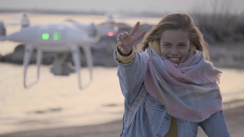 Funny Woman Making Video on the Beach Using Drone