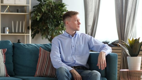 Middle Aged Man Sitting on Couch