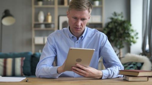 Man Using Tablet in Modern Home Office
