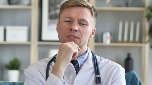 Thoughtful Doctor Pondering in Professional Workplace Setting