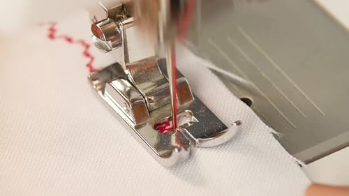Close up of Sewing Machine Stitching White Fabric