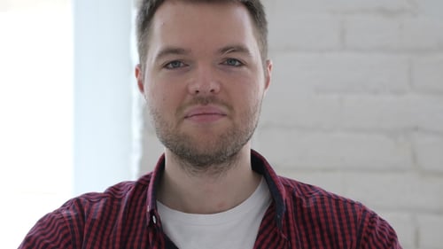 Man Gives Okay Hand Sign and Smiles