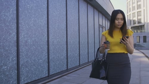 Asian Office Worker Using Phone, Drinking Coffee