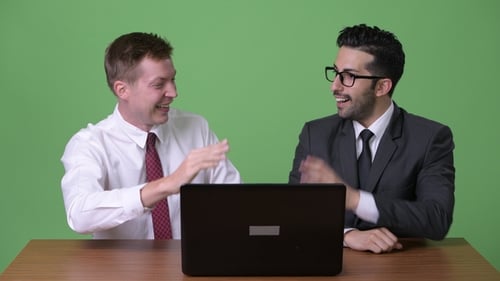 Two Men Celebrate Achievement in a Corporate Setting