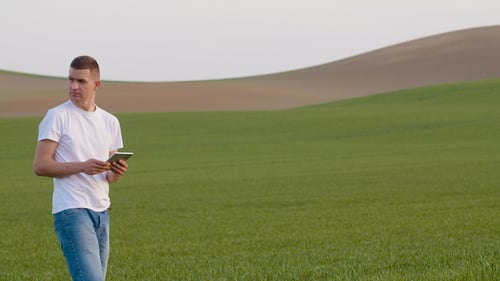 Farmer Using Digital Tablet on Agricultural Field