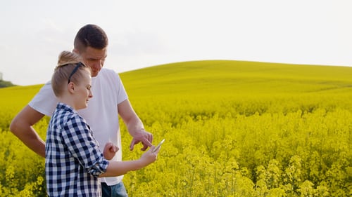 Farmers Discussing While Using Tablet Computer At Farm