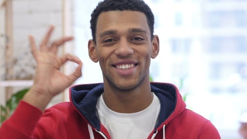 Young Adult Gives the OK Sign