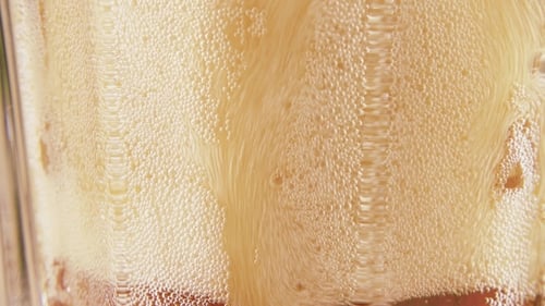 Bubbles and Ice in a Brown Soda