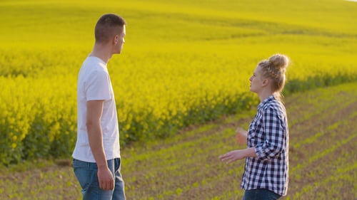 Farmers Talking While Shaking Hands At Farm