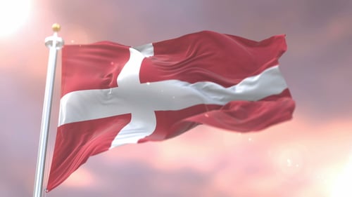 Danish Flag Waving Against Cloudy Sky with Sun Glare