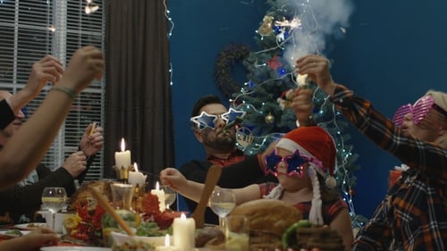 Family Celebrates with Sparklers at Christmas Dinner