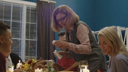 Woman Serving Holiday Turkey for Family