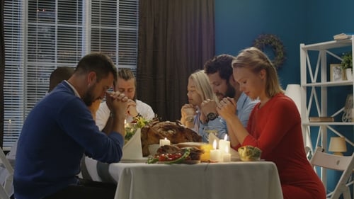 Group of Friends Praying on Thanksgiving Day Celebration