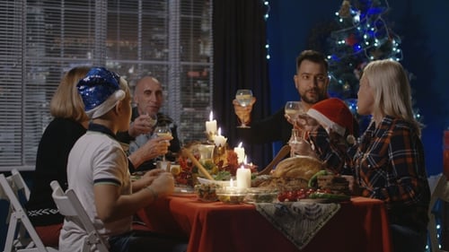 Family Toasting at Christmas Dinner Celebration at Night