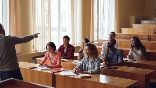 Professor Teaching to Young Adults in Classroom