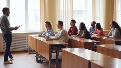 Friendly Teacher Is Talking To Students Asking Questions While Young People Are Raising Hands