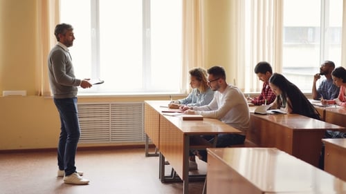 Teacher lecturing to students in classroom