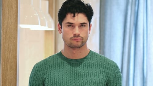 Young Man Looking Seriously Directly at Camera